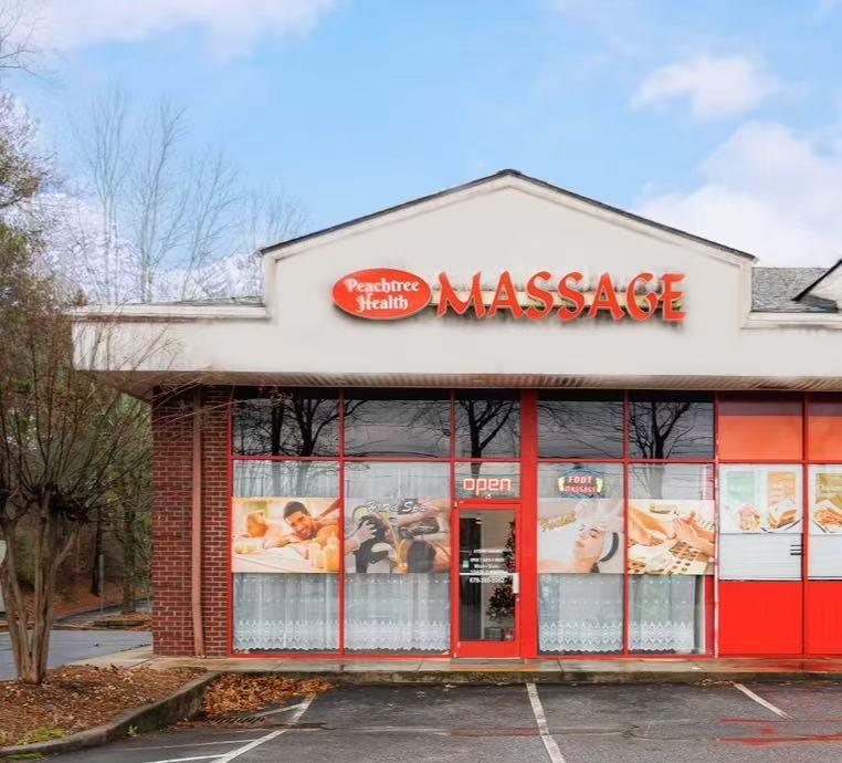 The Peachtree Health Massage storefront with its red sign