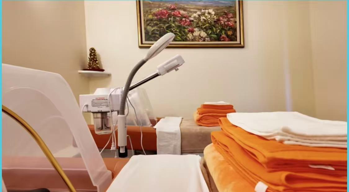 Our facial room with a steamer and folded orange towels