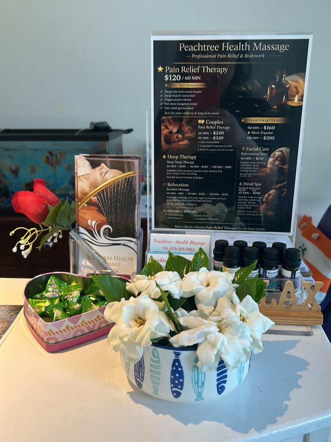 Our reception counter with fresh flowers and the treatment menu